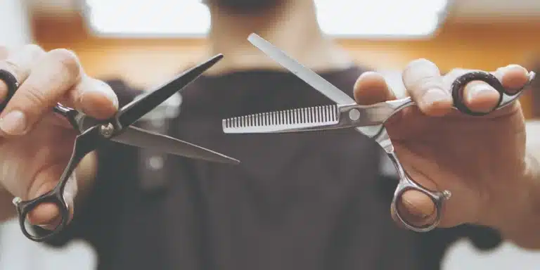 Barber with sharpened shears at the chair