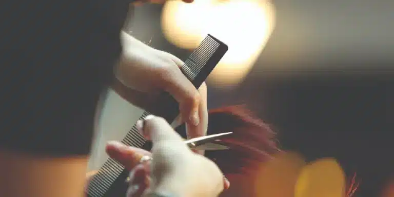 Stylist cutting hair with sharpened shears